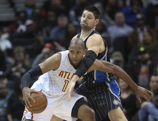 Atlanta Hawks center Al Horford left is defended by Orlando Magic center Nikola Vucevic right in the second half of an NBA basketball game Monday Feb. 8 2016 in Atlanta. Orlando won 117-110 in overtime