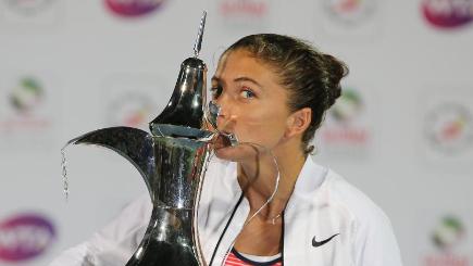 Sara Errani celebrates with the Dubai Duty Free Tennis Championships trophy