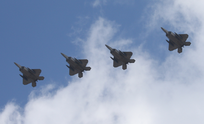 F-22 stealth jets deployed by the U.S. fly over Osan Air Base in Pyeongtaek Gyeonggi Province Wednesday