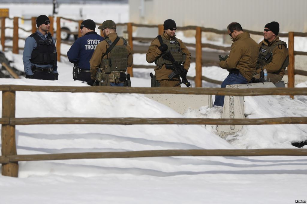 FILE- Members of the Oregon State Troopers and FBI are seen as in Burns Oregon Jan. 31 2016. Four armed occupants remain at the Malheur National Wildlife Refuge near Burns