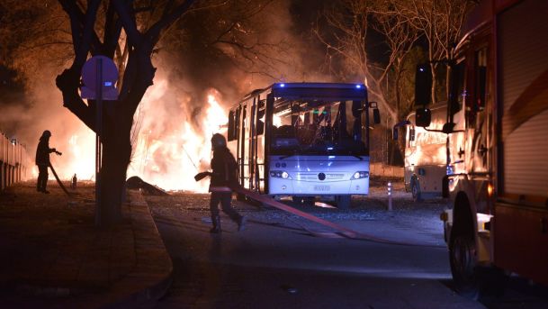 Firefighters try to extinguish flames following an explosion targeting a convoy of military service vehicles Ankara