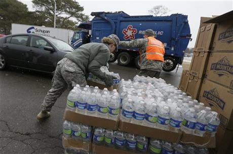 Members of the Michigan National Guard load bottled water at a fire station Thursday Jan. 28 2016 in Flint Mich. The Michigan Legislature voted Thursday to direct another $28 million to address Flint's water emergency allocating money for bottle