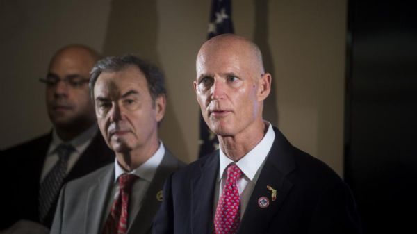 Florida Gov. Rick Scott right speaks at