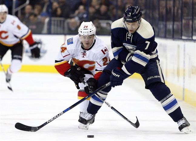 Calgary Flames Jiri Hudler left of the Czech Republic and Columbus Blue Jackets Jack Johnson chase the puck during NHL hockey action in Columbus OH