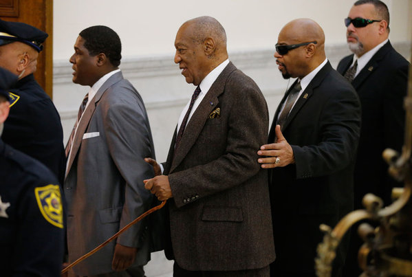 Bill Cosby center and security team return to Courtroom A in a single file line after a lunch break on Wednesday afternoon at the Montgomery County Courthouse in Norristown PA. The pre-trial hearing for entertainer Bill Cosby and his sexual assault cas