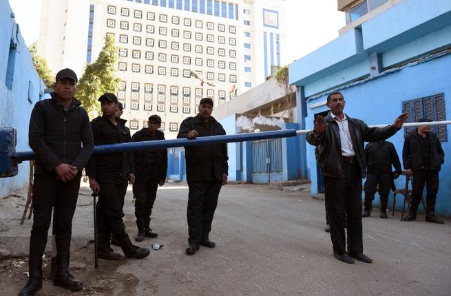 Egyptian security stand guard outside the Zeinhom morgue in Cairo where the body of Giulio Regeni a 28-year-old Italian graduate student is being held