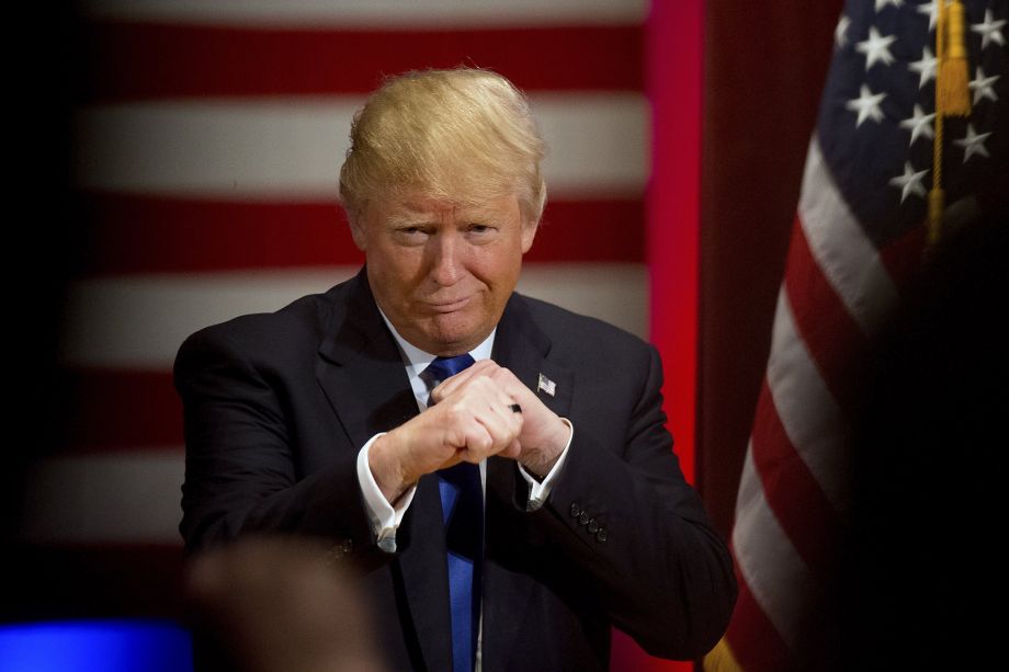 Republican presidential candidate Donald Trump poses with a ring given to him by a group of veterans during a campaign event on the campus of Drake University Thursday Jan. 28 2016 in Des Moines Iowa