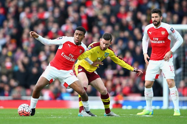 Alex Iwobi of Arsenal controls the ball under pressure of David Jones of Burnley