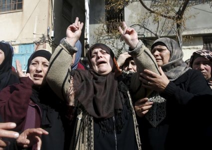 The mother of Palestinian youth Omar Madi who was shot and killed by Israeli troops on Wednesday mourns during his funeral in Arroub refugee camp north of the West Bank city of Hebron