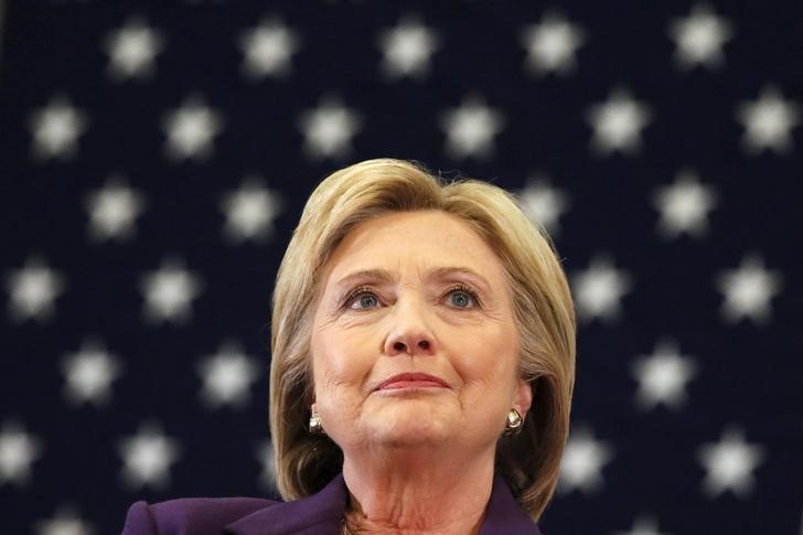 U.S. Democratic presidential candidate Hillary Clinton is backdropped by a U.S. flag during a campaign rally at Winnacunnet High School in Hampton New Hampshire