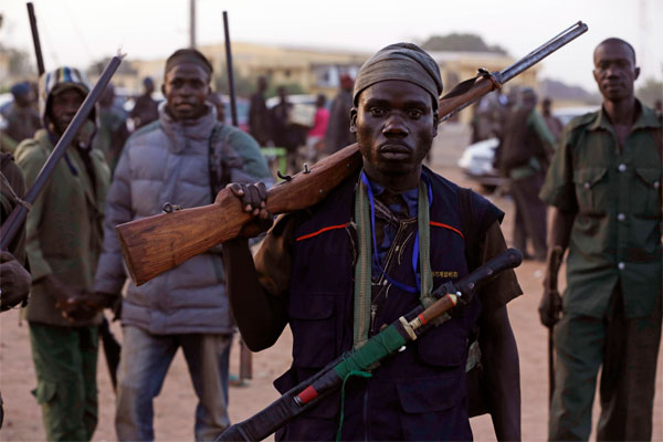 Vigilantes from the village of Yola Nigeria prepare to go on patrol in November 2014. The area has been ravaged by Boko Haram violence