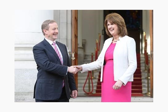 Irish Prime Minister Enda Kenny left shakes hand with Tanaiste Joan Burton outside Government Buildings in Dublin Wednesday Feb. 3 2016. Irish Prime Minister Enda Kenny announced a Feb. 26 election Wednesday that will pit his 5-year-old government’s