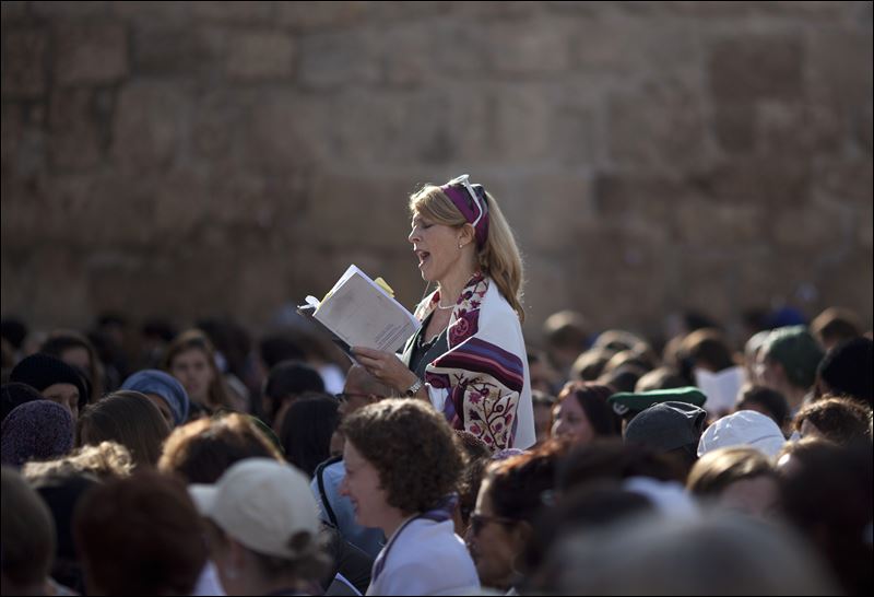 A Jewish woman wears a prayer shawl as she prays at the Western Wall the holiest site where Jews can pray in Jerusalem's Old City. Israeli Prime Minister Benjamin Netanyahu is advancing a plan to allow non Orthodox Jewish prayer at the Western Wall