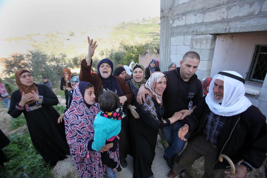 JENIN WEST BANK- FEBRUARY 14 Their relatives mourn during the funeral ceremony of 2 15-year-old Palestinian teenagers namely Nihad Raid and Fuad Mervan who have been killed by Israeli soldiers at El Arka town of Jenin West Bank