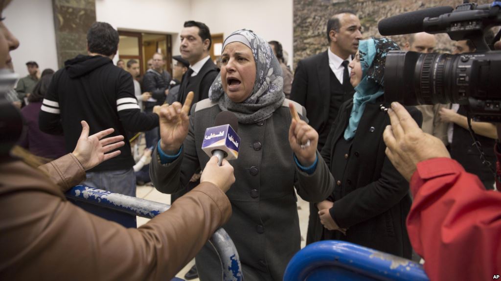 Suha Abu Khdeir center mother of Mohammed Abu Khdeir a 16-year-old Palestinian murdered in 2014 speaks to reporters at a court during the sentencing of two Israelis accused of his murder in Jerusalem Feb. 4 2016