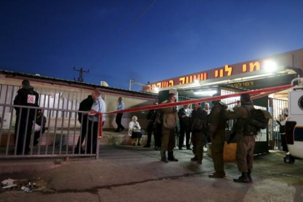 Israeli troops gather near the scene of a stabbing attack near the West Bank city of Ramallah