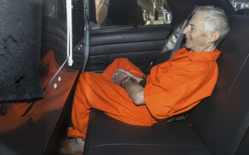 Robert Durst sits in a police vehicle as he leaves a courthouse in New Orleans Louisiana