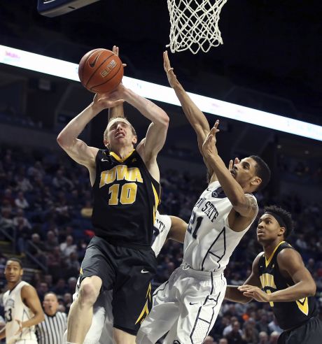 Iowa guard Mike Gesell is fouled by Penn State forward Brandon Taylor on his way to the basket during the second half of an NCAA college basketball game in State College Pa. Wednesday Feb. 17 2016