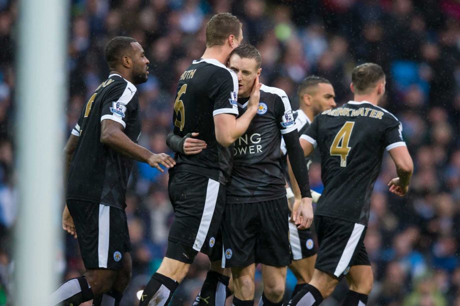 Leicester City's Robert Huth centre left facing away from camera celebrates with teammate Jamie Vardy after scoring during the English Premier League soccer match between Manchester City and Leicester City at the Etihad Stadium in Manchester England S