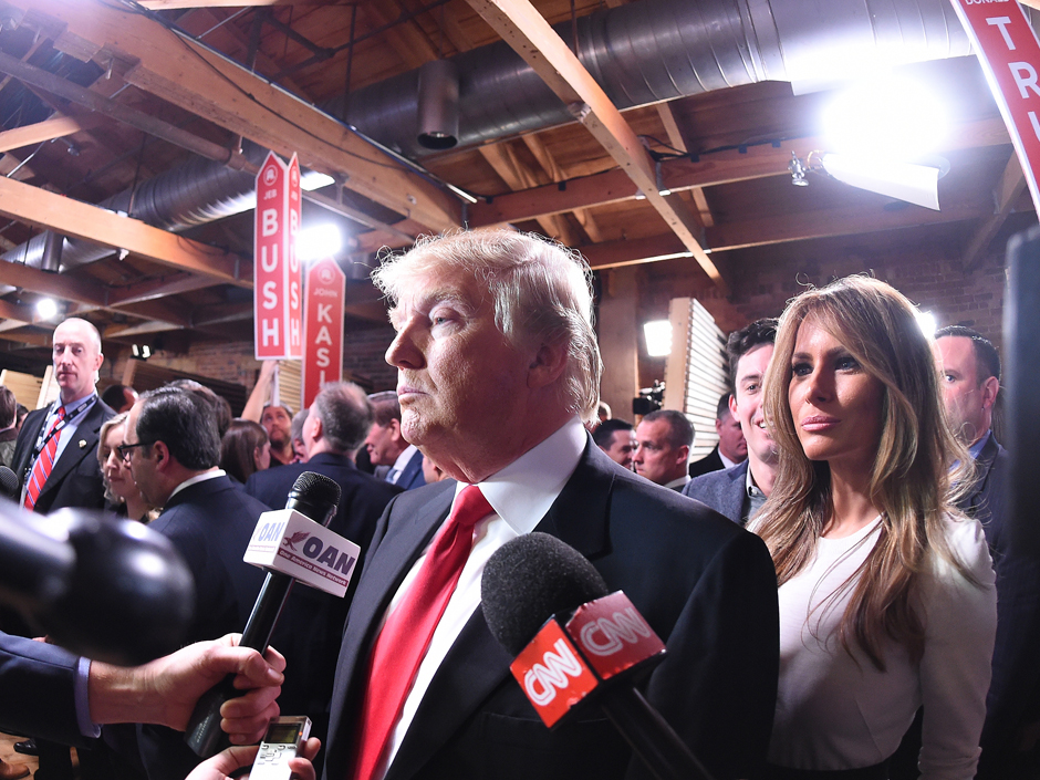 Republican presidential candidate businessman Donald Trump with his wife Melania Trump at right speaks to the media in the spin room after the CBS News Republican presidential debate at the Peace Center Saturday Feb. 13 2016 in Greenville S.C