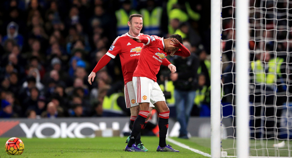 Jesse Lingard celebrates with Wayne Rooney after scoring the opening goal of the game