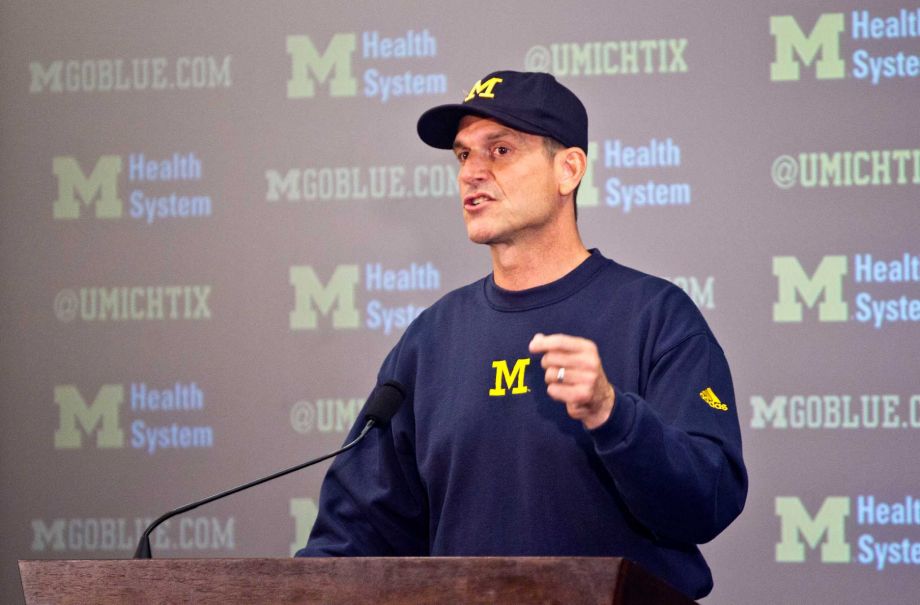 Michigan head coach Jim Harbaugh speaks at a press conference during the NCAA college football team's annual media day in Ann Arbor Mich. Jim Harbaugh has come up with another way to get in the spotlight. Michigan