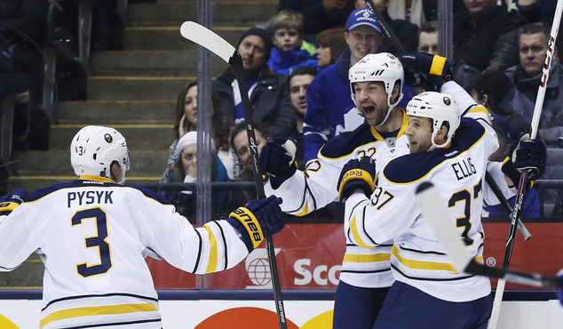 Buffalo Sabres John Scott center celebrates his goal with teammates Mark Pysyk left and Matt Ellis against the Toronto Maple Leafs during the first peri