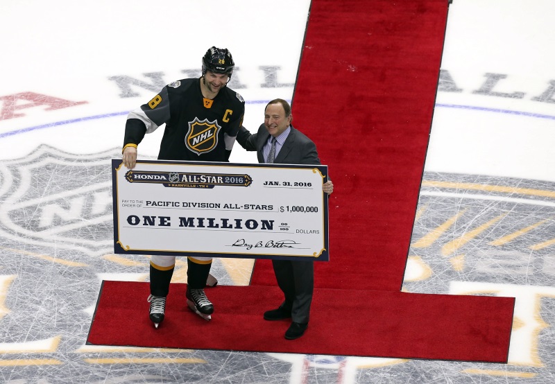 John Scott is presented with the check for $1 million after winning MVP at the NHL All Star game