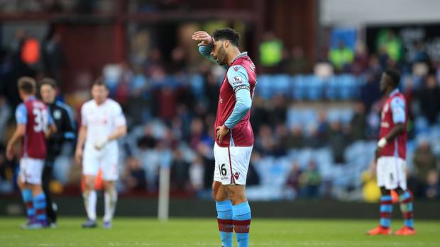 Joleon Lescott looks dejected after Villa concede their third goal against Liverpool
