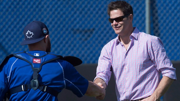 Blue Jays GM Ross Atkins seen here greeting catcher Russell Martin at spring training in Dunedin Fla. on Tuesday is remaining tight-lipped when it comes to Jose Bautista's contract negotiations and trade rumours involving fellow outfielder Michael