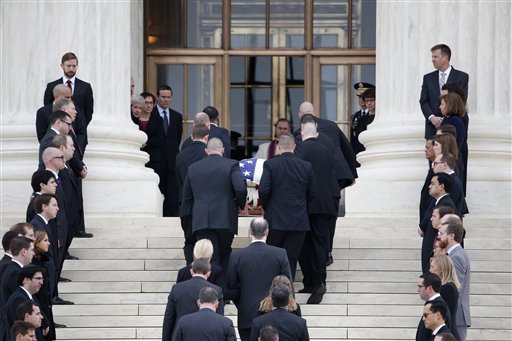 The body of Justice Antonin Scalia arrives at the Supreme Court in Washington Friday Feb. 19 2016. Thousands of mourners will pay their respects Friday for Justice Antonin Scalia as his casket rests in the Great Hall of the Supreme Court where he spen