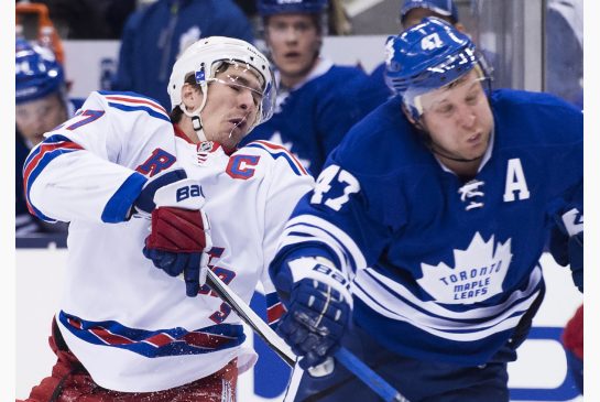 Toronto Maple Leafs centre Leo Komarov hits New York Rangers defenceman Ryan Mc Donagh in the head during first period NHL hockey action in Toronto on Thursday