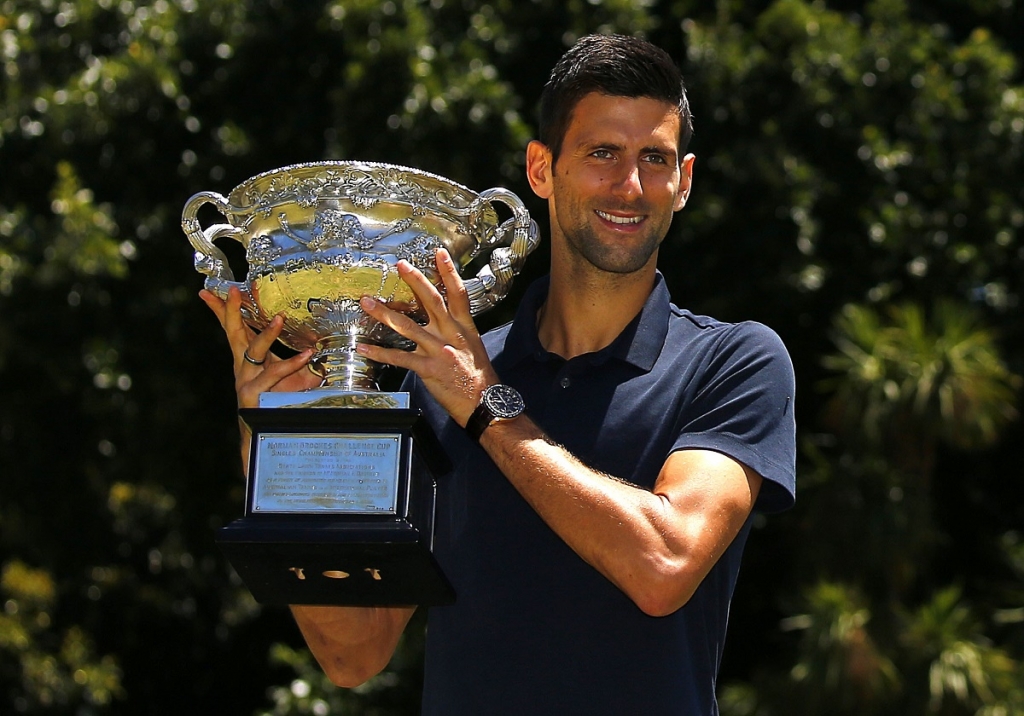 Serbia's Novak Djokovic poses with the men's singles trophy a day after winning his final match at the Australian Open tennis tournament at Government Hill in Melbourne Australia