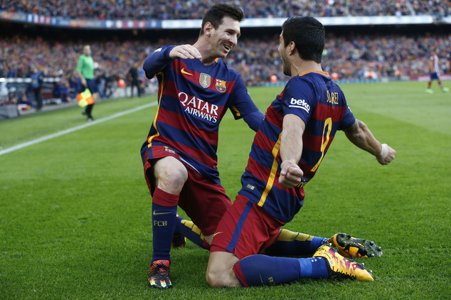 FC Barcelona's Luis Suarez right reacts after scoring with his teammate Lionel Messi against Atletico Madrid during a Spanish La Liga soccer match at the C