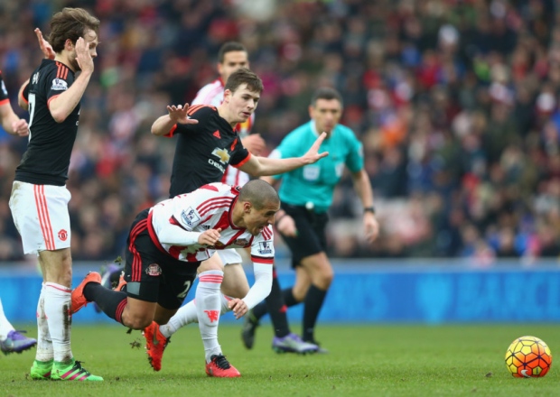 Manchester United's Donald Love centre tackles Wahbi Khazri of Sunderland