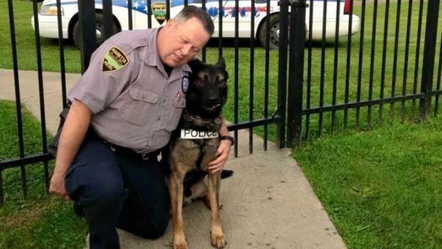 Matthew Hickey puts his arms around K-9 partner Ajax