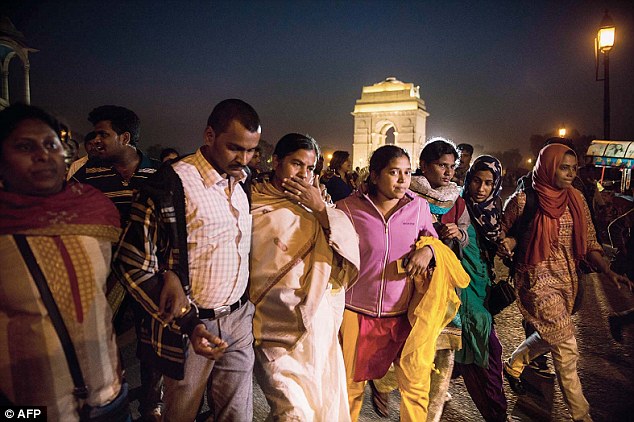 Rohith Vemula’s mother Radhika Vemula walks with students and activists during a candlelight protest against the Centre's'war on students at India Gate in New Delhi