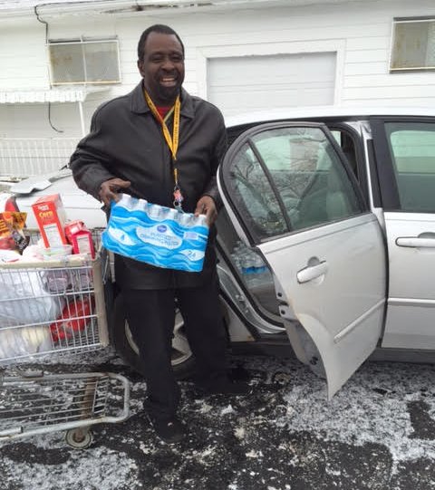 A Flint resident picking up water from an Adventist Community Services distribution point