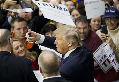 Republican presidential candidate Donald Trump gestures to the crowd as he signs autographs at a campaign event at Plymouth State University Sunday Feb. 7 2016 in Plymouth N.H