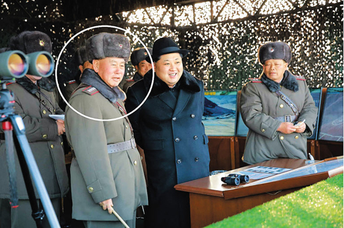 New North Korean Army chief Ri Myong-su sits beside leader Kim Jong-un during a military drill in this