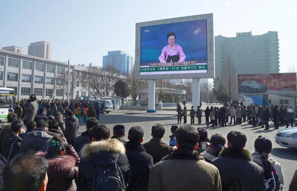 North Koreans watch a huge screen broadcasting an official announcement that the country “successfully” put an Earth observation satellite into orbit calling it an “epoch-making” achievement in Pyongyang North Korea