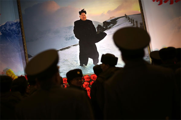 North Korean soldiers stand before a portrait of their leader Kim Jong Un on Feb. 15- a day before the birthday anniversary of his father Kim Jong Il