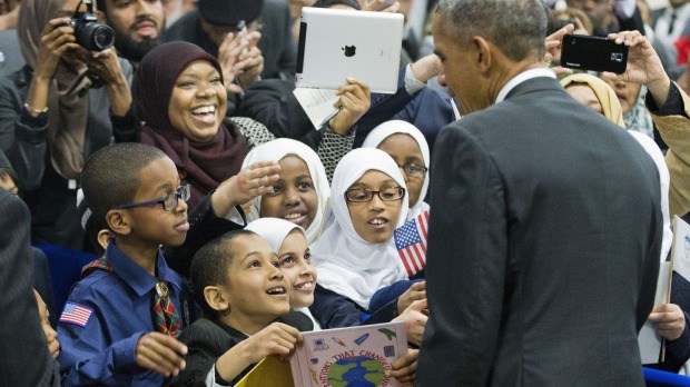 President Barack Obama greets children from al Rahmah school and other guests during his visit to the Islamic Society