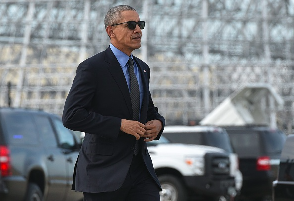 President Barack Obama makes his way to board Air Force One upon departure from Moffett Federal Airfield in Mountain View California