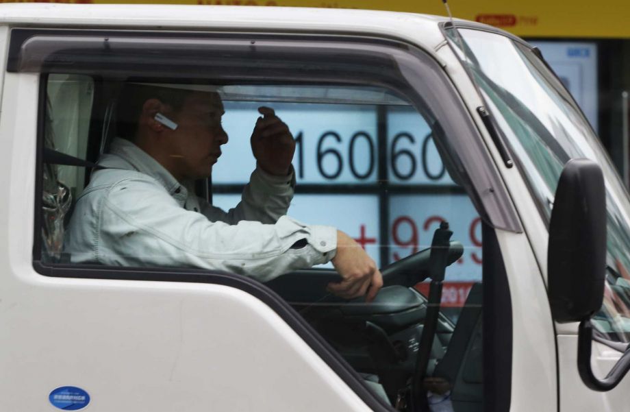 Japan's Nikkei stock 225 index is seen through a car window near a securities firm in Tokyo Monday Feb. 22 2016. Asian stock markets rebounded Monday as investors looked to this week's meeting of finance ministers from major economies for reassurance