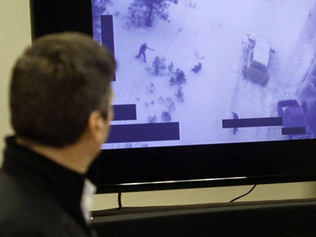 FBI special agent Greg Bretzing looks at a video of the shooting death of Robert'LaVoy Finicum as he addresses the public at the Harney County Chamber of Commerce meeting in Burns Oregon