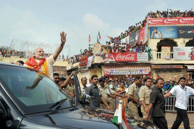 Prime Minister Narendra Modi waves at the crowd during his visit to Jagannath temple in Puri on Sunday