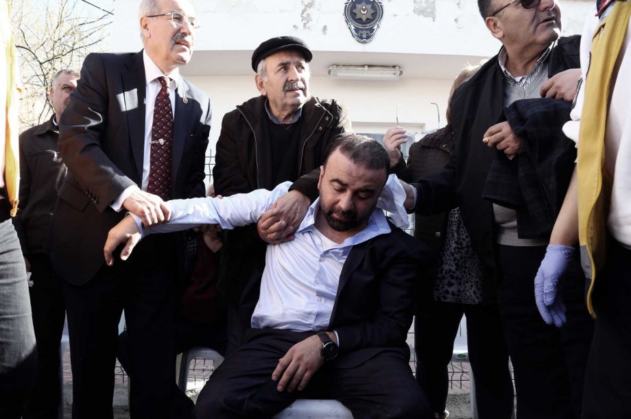 Medics and people help a collapsed relative of a victim outside the medical forensics site in Ankara Turkey Thursday Feb. 18 2016. A Syrian national with links to Syrian Kurdish militia carried out the suicide bombing in Ankara that targeted military