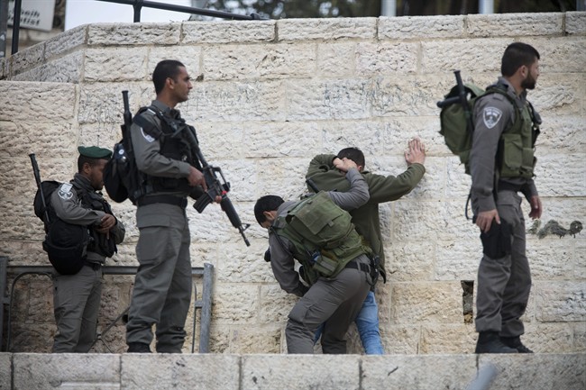 Israeli border police officers body-search a Palestinian at Damascus Gate in Jerusalem's Old City Thursday Feb. 18 2016. Israel has significantly beefed up security outside Jerusalem's Old City lately especially at Damascus Gate which has been the sce