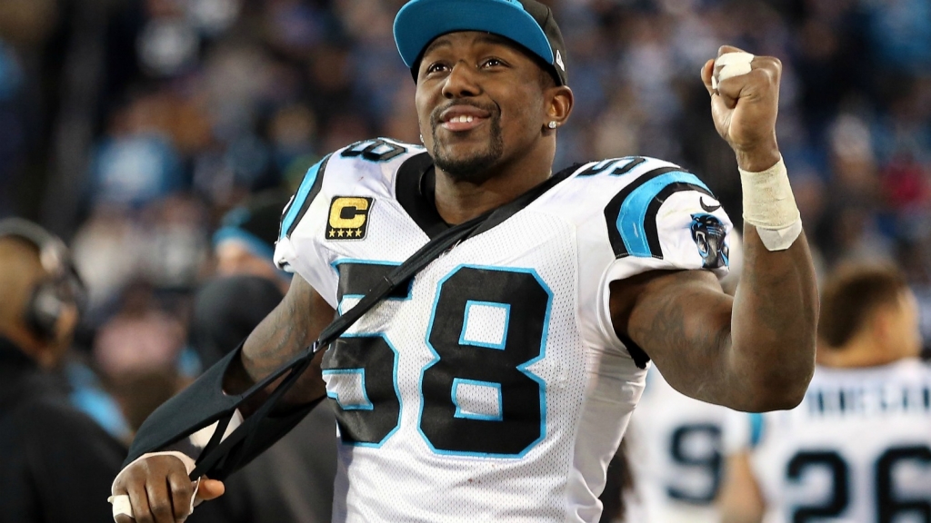 An injured Thomas Davis #58 of the Carolina Panthers celebrates in the fourth quarter against the Arizona Cardinals during the NFC Championship Game at Bank of America Stadium